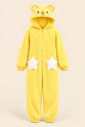 A person wearing a fluffy yellow bear-themed hooded onesie with white star patches on the legs, taking a mirror selfie in a bedroom setting.