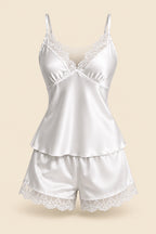 A woman modeling a white satin camisole and matching shorts set with lace trim in an indoor bathroom-like setting. The image includes the brand text 'ASAAL Designs' at the top right, a small inset showing the same model, and a blue 'Code 229' label at the bottom right.