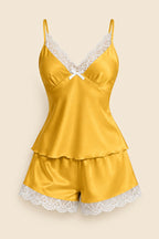 A woman models a satin two-piece lingerie set in mustard yellow with white lace trim, featuring a camisole top and matching shorts. The image includes an inset showing the full outfit, a brand logo 'ASAAL Lingerie' in the top right, and a code label 'Code 229' in the bottom right.