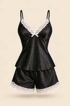 A woman models a black satin slip set with white lace trim, featuring a camisole top and matching shorts. The image includes an inset of the model wearing the set, a brand logo 'ASAAL Ladies' in the top right, and a code label 'Code 229' in the bottom right.