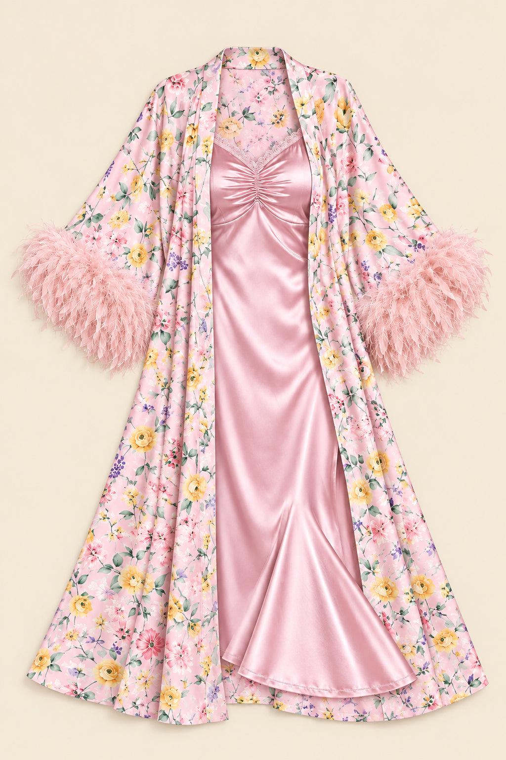 A pink floral robe with fluffy feathered cuffs, layered over a satin pink slip dress, displayed against a solid beige background.