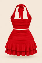 A woman modeling a bright red two-piece halter crop top and matching ruffled mini skirt, shown in front and back views. The image has a pink 'Divi shop' logo at the top and contact details at the bottom.