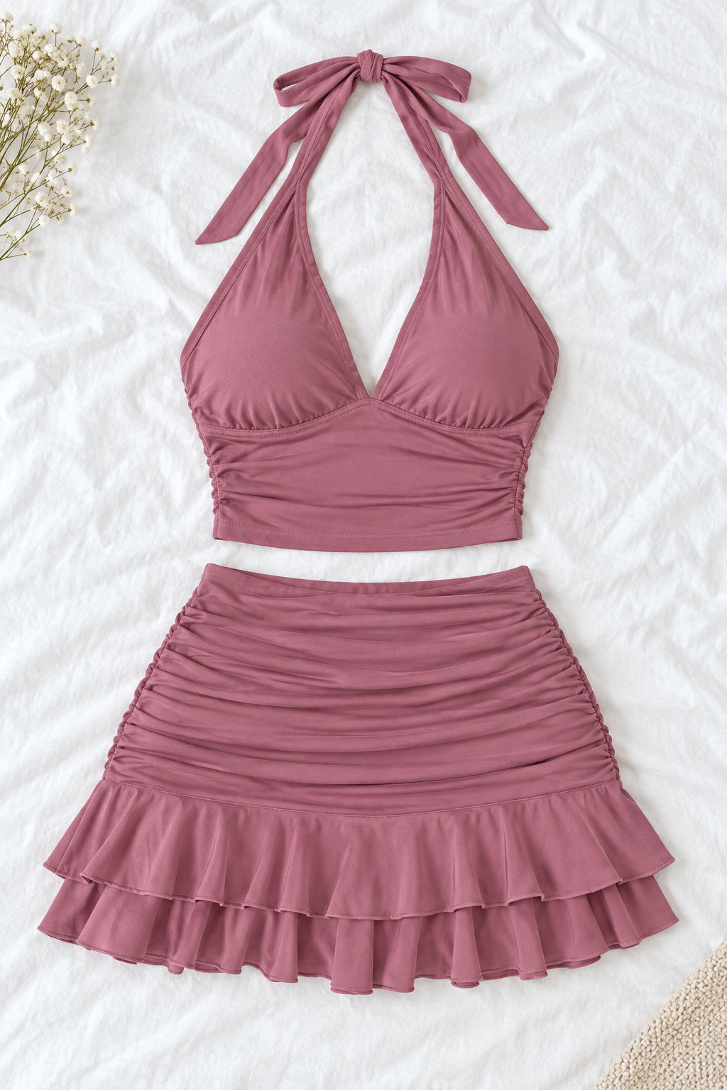 A woman modeling a dusty rose halter crop top and matching ruffled mini skirt, shown in front and back views side by side. The image includes a 'Diaa shop' logo at the top, a phone number at the bottom left, and a code at the bottom right.