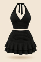 A woman modeling a black two-piece outfit consisting of a halter crop top and a ruched ruffled mini skirt, shown in front and back views side by side. The image has a pink 'Diva shop' logo at the top and contact details at the bottom.