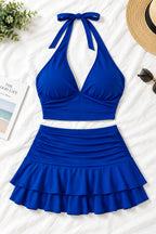 A woman modeling a royal blue two-piece halter set with a deep V-neck crop top and a ruffled mini skirt, shown in front and back views on a split background. A pink 'Diaou shop' logo is visible at the top, with contact details and 'Code:0120' at the bottom.