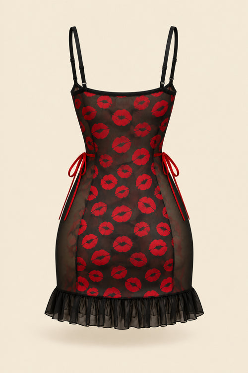 A woman models a black mini dress with red lip print and sheer mesh panels in a warmly lit bedroom setting. Two smaller inset views on the right show the dress from different angles, and text overlays include 'JOY ENA Lingerie', 'Size Free Size Model 1342', and promotional copy.