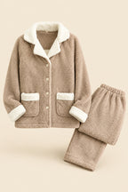 A two-piece fleece pajama set in a warm taupe-beige color with contrasting white sherpa lining, featuring a long-sleeve button-front top with pockets and matching pants. The set is displayed on a white background with a brand logo in the top right and a code label in the bottom left.